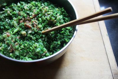 High angle view of salad in bowl on cutting board