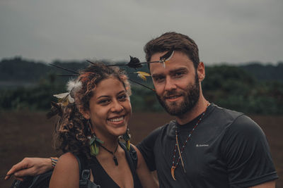 Portrait of smiling friends against sky