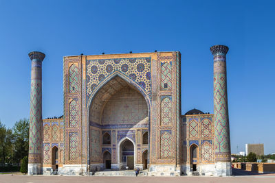 Low angle view of historic building against clear blue sky