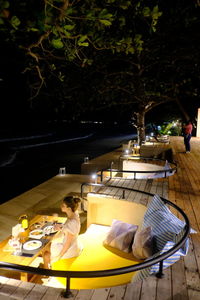 High angle view of people sitting on table at restaurant