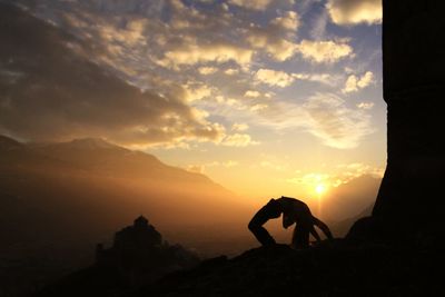 Silhouette of person against sky during sunset