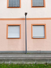 Low angle view of street light against building