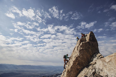 Rock climbers reach summit of a peak in the grand tetons, wyoming