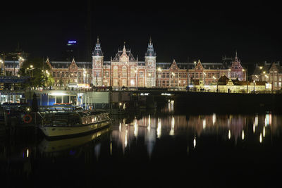 Illuminated buildings in water at night