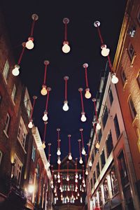 Low angle view of illuminated chandelier hanging in city