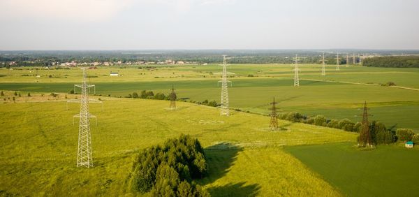 Scenic view of grassy field against sky