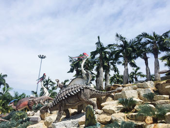 View of statue by plants against sky