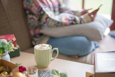 Midsection of woman using mobile phone on table