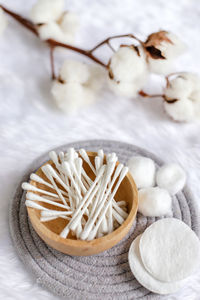 High angle view of cotton with swab and wipes on table