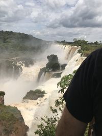 Scenic view of waterfall against sky