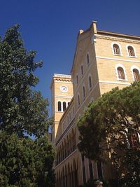 Low angle view of clock tower against clear sky