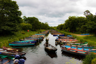 Boats moored in river