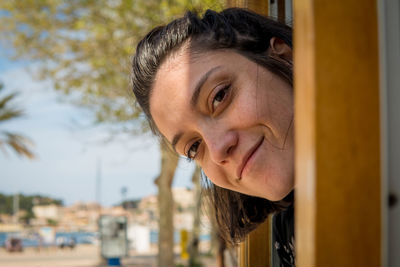 Close-up portrait of smiling young woman outdoors