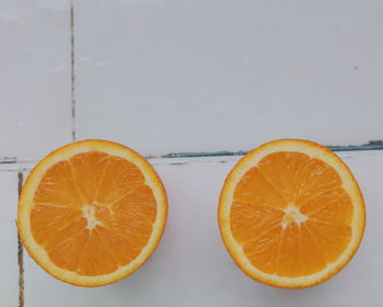 Directly above shot of halved orange on table