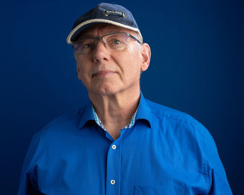 Senior man against blue background