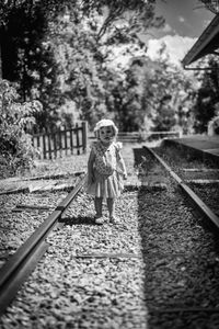 Full length of child on railway tracks