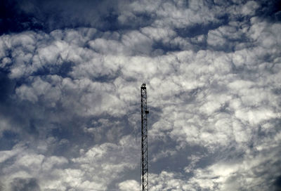 Low angle view of communications tower against sky