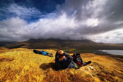 Scenic view of landscape against cloudy sky