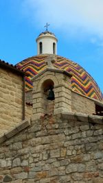 Low angle view of bell tower against sky