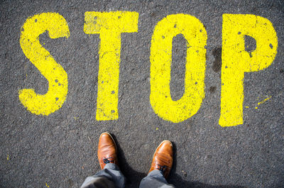 Low section of man by stop sign on street