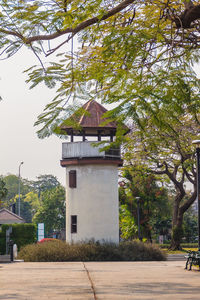 Exterior of building by trees against sky