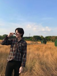 Man wearing sunglasses while standing on landscape