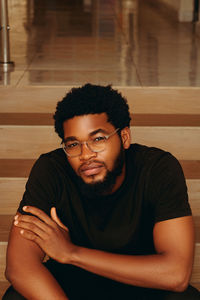 Portrait of young man sitting at home