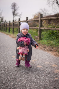 Full length of woman standing on road