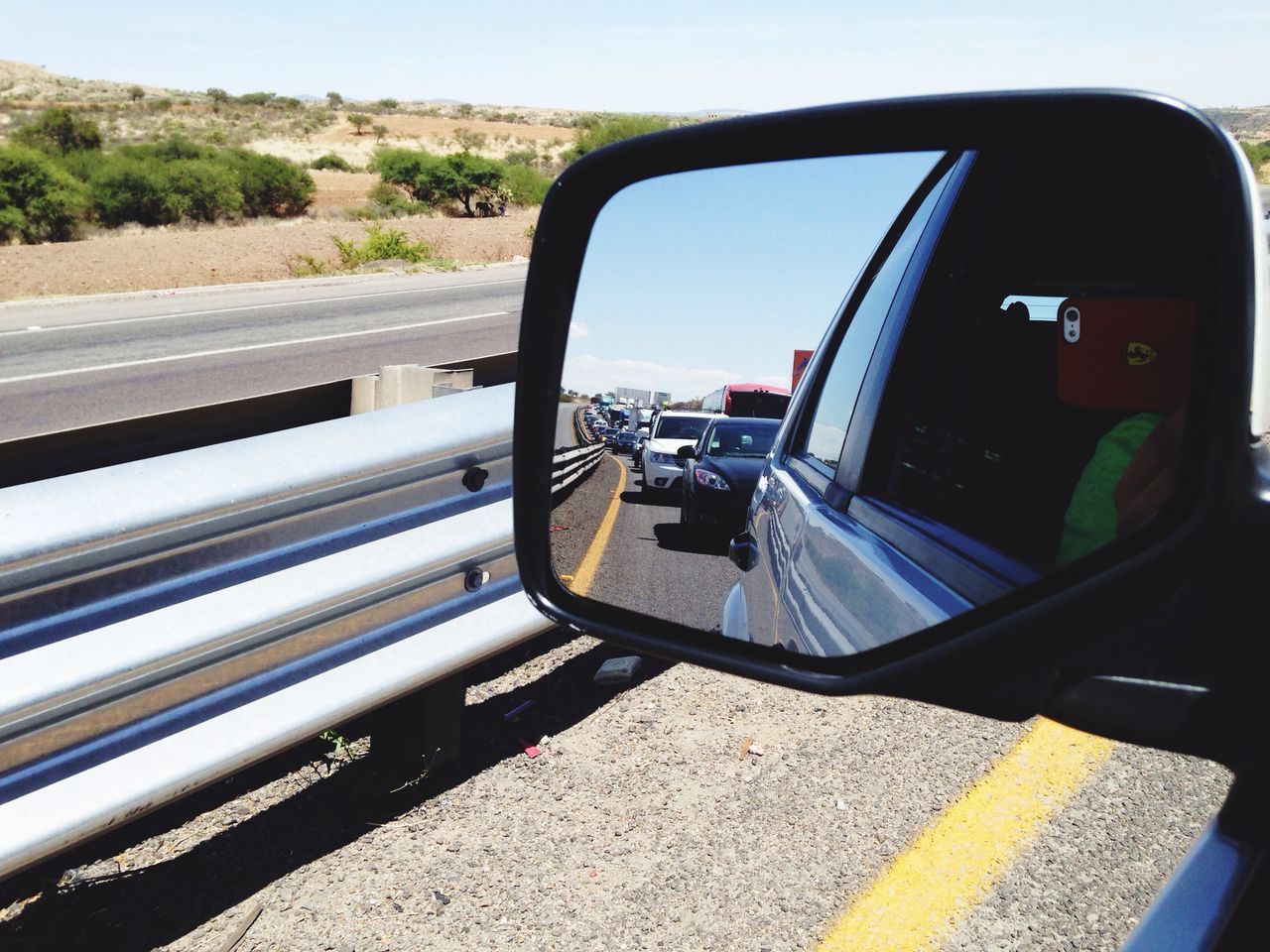 transportation, mode of transport, land vehicle, car, road, street, road marking, travel, sky, side-view mirror, day, highway, vehicle interior, on the move, vehicle, part of, cropped, outdoors, car interior, no people