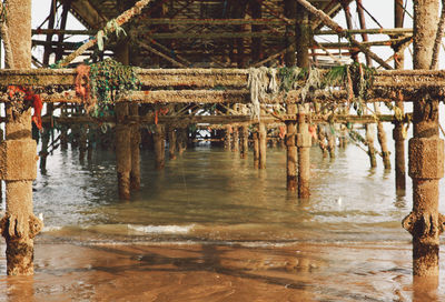 Low angle view of rusted jetty over water