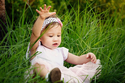 Portrait of cute girl lying on field