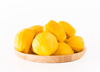 Close-up of fruits in plate against white background