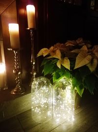 Close-up of illuminated lamp on table at home