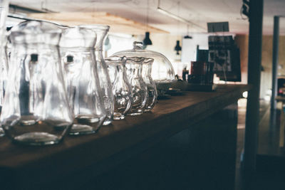 Empty glass jugs on counter at bar