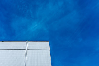 Low angle view of white building against blue sky