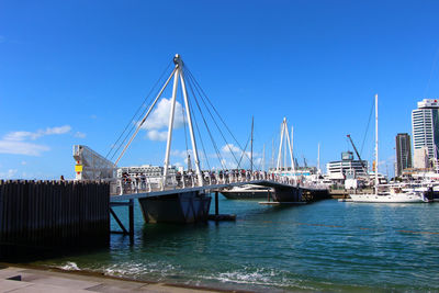 Sailboats in sea against clear blue sky