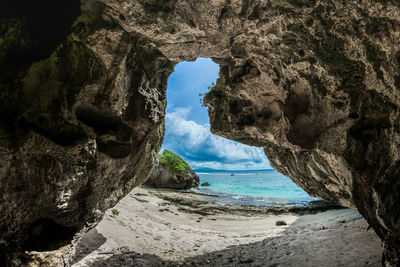 Scenic view of sea seen through cave