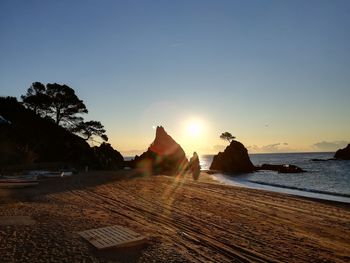 Scenic view of beach against sky during sunset