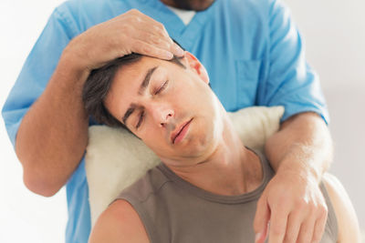 Man receiving massage therapy in spa