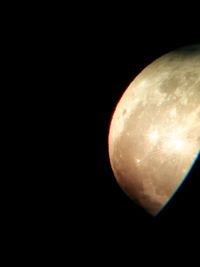 Low angle view of moon against black background