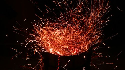 Low angle view of firework display at night
