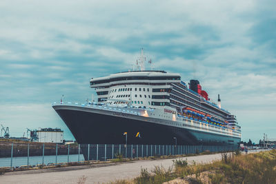 View of ship in sea against cloudy sky