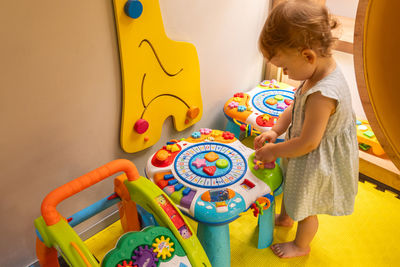 High angle view of boy playing with toys on table