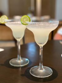 Close-up of two frozen margaritas cocktails on table