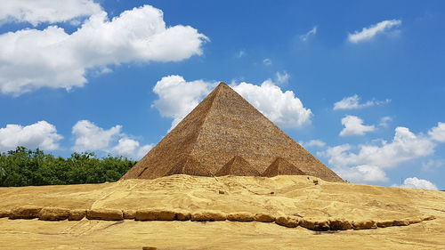 Ancient temple against sky pyramid