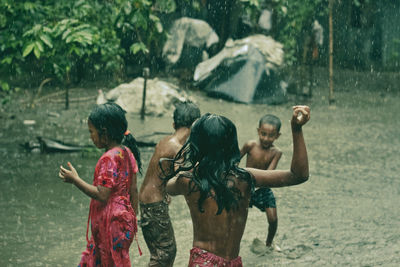 Group of people on wet landscape during rainy season