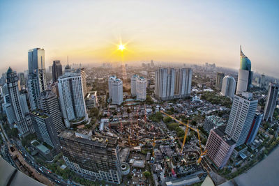 Aerial view of city buildings during sunset