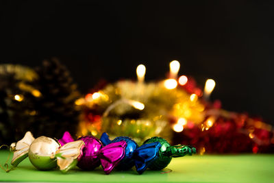 Close-up of illuminated candles on table