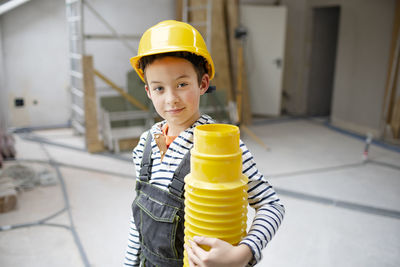 Portrait of boy standing against wall