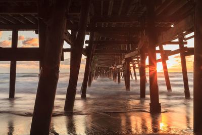 Low angle view of bridge at calm sea